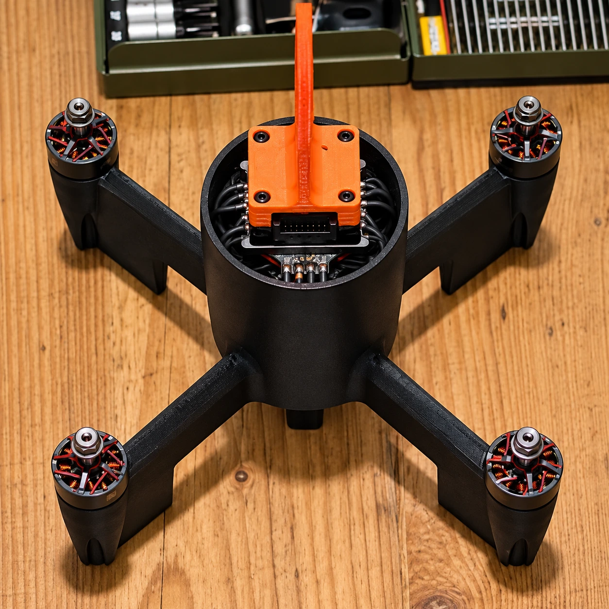 Structura dronei, patru brațe cu motoare și suport portocaliu pentru componentele electronice